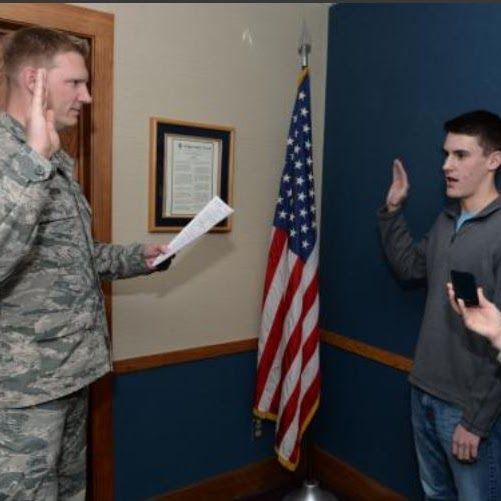 Taking the Oath of Enlistment in front of the U.S. flag