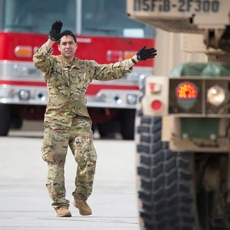 Air National Guard Airman directing vehicle operations